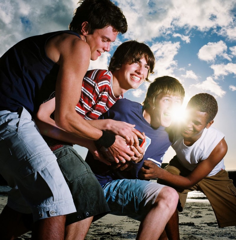 Group of Young Men Wrestling Playfully --- Image by © Royalty-Free/Corbis